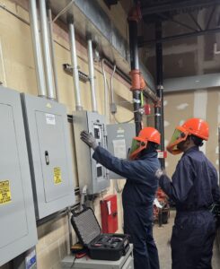 Electricians performing a thermal imaging inspection on electrical equipment