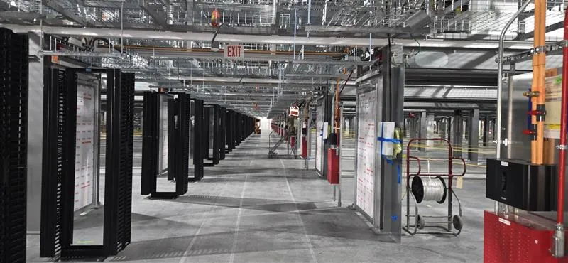 Electrical infrastructure and equipment rows inside a data center facility